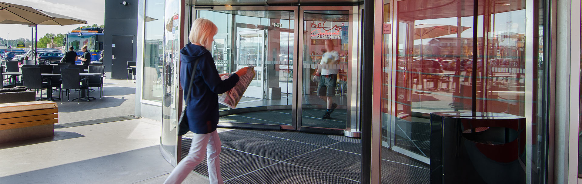 Main-entrance-revolving-door-woman-reading-1920x607